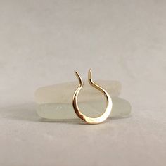 a close up of a gold ring on a white surface