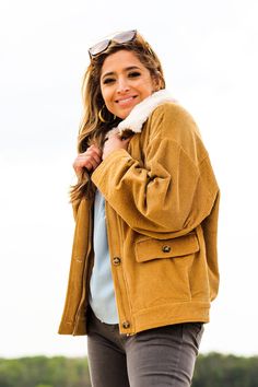 Complete any look with this stylish and comfortable jacket! -Color: Camel -Removable faux fur collared -Button down/ Zip up -Side flap pockets -Oversized silhouette -Content: 100% Cotton -Imported -Model is 5'5" 36-30-40 and wearing a size Small Collared Utility Jacket With Buttoned Pockets For Winter, Fall Collared Outerwear With Faux Fur Lining, Winter Collared Utility Jacket With Button Closure, Trendy Winter Utility Jacket With Buttoned Pockets, Collared Utility Jacket With Button Closure For Winter, Trendy Collared Outerwear For Cold Weather, Winter Utility Jacket With Corduroy Collar, Winter Corduroy Button-up Utility Jacket, Winter Utility Jacket With Corduroy Collar Button-up