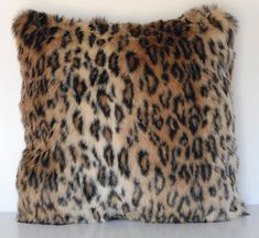 a leopard print pillow on a white surface