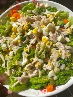 a white bowl filled with salad on top of a table