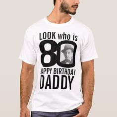 a man wearing a white t - shirt with the words, look who is 80 happy birthday daddy