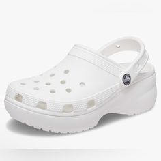 Platform Shoes For Women: Reach New Heights With These Platform Crocs For Women. They Feature The Comfort And Style You Love About The Regular Classic Clogs, Plus A 1.6-Inch Platform Sole All The Way Around. Fun Platform Crocs: These Are The Crocs Women Need And They Come In A Range Of Colors. The Crocs Classic Platform Clogs Are Incredibly Lightweight And Fun To Wear. Comfortable And Lightweight: Crocs Platform Clogs For Women Have The Iconic Crocs Comfort Technology, Made For Flexibility And 3 Crocs White Platform, Crocs Platform Clog, Platform Crocs, Classic Icon, Bday List, Crocs Fashion, College List, Clogs Style, Platform Clogs