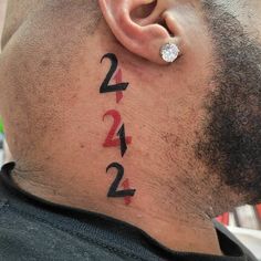 a man's ear with numbers tattooed on it