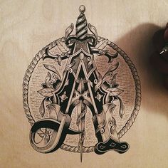 a hand holding a pen and ink drawing of an all seeing triangle with scissors on it