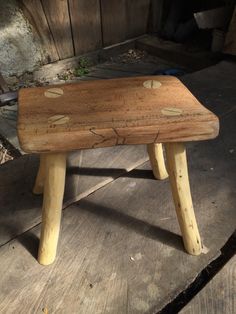 a wooden bench sitting on top of a wooden floor