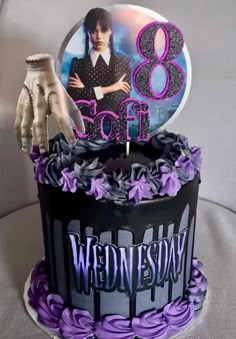 the birthday cake is decorated with purple icing and has an image of elvis presley on it