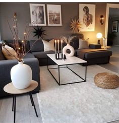 a living room filled with lots of furniture and candles on top of the coffee table