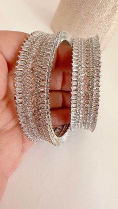 Rhodium Finish American Diamond/CZ Bangles/Bracelet/Indian Party Wear Bangles/ CZ stone bangles/Indian wedding/bridal jewelry Plating-Rhodium Finish Opening :Not a  Screw type It is made by our artisans using expert techniques, so it sparkles and shines over the years. Best gift option for your loved ones comes in an exquisite gift box. Silver Diamond Cut Bracelet For Party, Dazzling Sparkling Bangle For Anniversary, Sparkling Dazzling Bangle For Anniversary, Silver Hoop Earrings With Sparkling Stones For Wedding, Wedding Bling Hoop Earrings In Metal, Cubic Zirconia Diamond Bracelet With Rhinestones, Cubic Zirconia Diamond Bangle With Rhinestones, Wedding Hoop Earrings With Bling, Sparkling Bangle For Anniversary