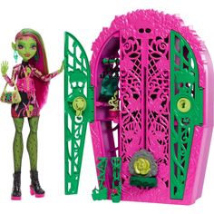 the monster doll is standing next to her pink and green playset with its door open