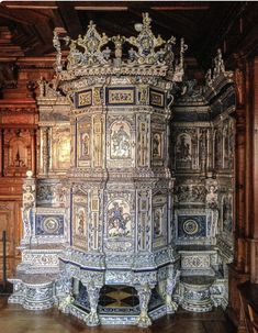 an elaborately carved wooden structure in a room with wood paneling and carvings on the walls