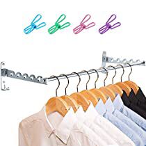 the clothes hangers are holding several pairs of shirts