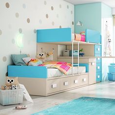 a child's bedroom decorated in pastel blue and white with polka dots on the walls