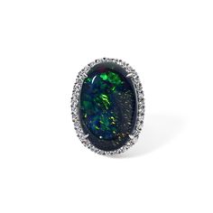 The Vintage Black Opal Cocktail Ring is part of our curated one-of-a-kind Vintage Collection. This modern estate cocktail ring features a rare and fiery oval shape natural black opal center stone beautifully framed by a halo of 34 round diamonds. Available in Platinum Available in a size 6.5 Ring can be resized between sizes 5-7 for an additional fee. Please contact our Team at info@stephaniegottlieb.com for more information. Opal weight = 17.39 carats Opal size = 24.15x15.79x7.10mm Diamond weig Black Oval Opal Ring For Formal Occasions, Black Oval Cabochon Opal Ring, Black Oval Opal Ring, Black Oval Opal Jewelry, Black Oval Opal Gemstone Ring, Oval Black Opal Jewelry, Black Oval Opal Ring For Anniversary, Oval Black Opal Ring For Anniversary, Black Oval Multi-stone Rings