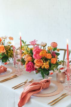 the table is set with flowers and candles