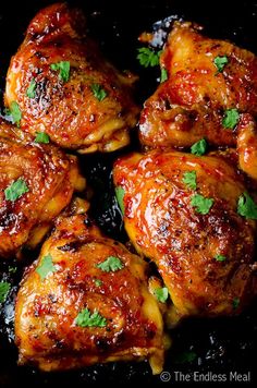 chicken wings with sauce and parsley in a skillet