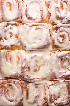 a close up view of cinnamon rolls with icing