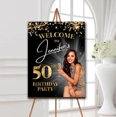 a black and gold 50th birthday sign with a woman holding a champagne glass in her hand