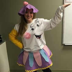 a woman in a costume poses for the camera with her arms out and one hand up