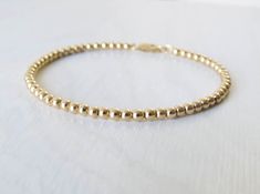 "Simple. Chic. Minimalist™ Perfectly dainty 3mm 14k gold filled beads are strung together on a high quality 14K Gold filled chain to make this versatile bracelet. You will GET NOTICED! Model wears 6.5\" Length. * Also available with Sterling silver/ 14K Rose gold filled chain. * Also available with 4mm beads- https://www.etsy.com/il-en/listing/271445053/ Or 5mm beads- https://www.etsy.com/il-en/listing/557470987/ This bracelet can also be made in any other beads size upon request. ❤️ Personalize Minimalist 14k Gold-filled Beaded Bracelets, Minimalist 14k Gold Beaded Bracelets, Minimalist 14k Gold Filled Bracelet With Round Beads, Minimalist Gold Beaded Bracelets, Minimalist Yellow Gold Bracelet With Gold Beads, Minimalist Gold Bracelet With Round Beads, Simple Gold Bracelet With Small Beads, Simple Gold Beaded Bracelet, Simple Gold Bracelet With Tiny Beads