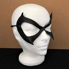 DESCRIPTIONSleek & sexy, lightweight leather Black Cat mask is an awesome costume accessory for Felicia Hardy, Ms. Marvel, Batgirl, Catwoman Cosplay or Halloween. Great convention mask; For villian & superhero cosplay, Halloween or Comicon. Spice up Valentine's Day! Any color. Waterproofed leather, glossy or matte finish, & several choices to affix the mask (cord, elastic, ribbon, waterproof cord, stick, or no holes for adhesive). Measurements: 7" high x 5" wide (tallest & widest Fitted Cat Ears Halloween Costume Accessories, Fitted Halloween Costume Accessories With Cat Ears, Gothic Mask Costume Accessories For Cosplay, Gothic Mask For Cosplay Costume Accessories, Themed Eye Mask For Costume Party, Gothic Mask For Cosplay, Fantasy Eye Mask For Cosplay, Punk Mask For Costume Party, Punk Style Mask Costume Accessories For Party