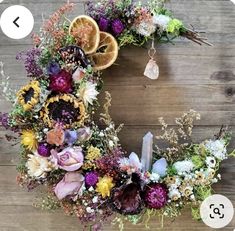 an image of a wreath with flowers and oranges