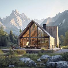 a wooden cabin in the mountains surrounded by grass and rocks