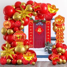 red and gold balloon decorations in front of a chinese arch with golden stars on it