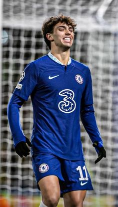 a soccer player is smiling while standing in front of the goal