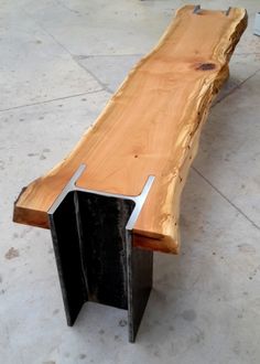 a large wooden bench sitting on top of a cement floor