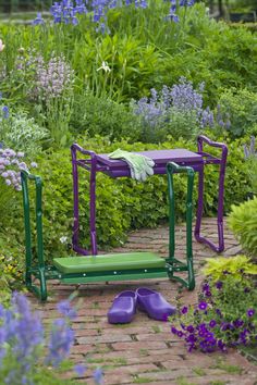 purple and green garden furniture in the middle of flowers