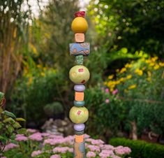 a colorful sculpture in the middle of a garden