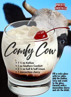 a cow with its head in a glass bowl filled with ice cream and cherries