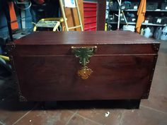 an old wooden chest with a clock on the front and sides, in a shop