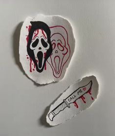 two pieces of paper with stickers on them that have been drawn onto the wall