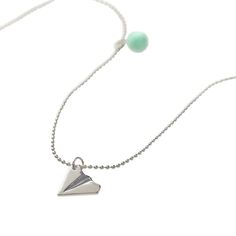 "Get the Calico Sun™ Silver Paper Airplane Emma Necklace at Michaels. com. Suspended from an adjustable silver ball chain necklace, the metal pendant is accented with a charming green pom pom for fashionable chic. This unique metal paper airplane shaped silver pendant will be a standout for anyone who wears it. Suspended from an adjustable silver ball chain necklace, the metal pendant is accented with a charming green pom pom for fashionable chic. For more high flying fun, pair with the Emma pap Playful Silver Charm Necklaces, Playful Adjustable Silver Necklace, Playful Adjustable Silver Charm Necklace, Emma Necklace, Silver Paper, Paper Airplane, Ball Chain Necklace, Toned Paper, Paper Airplanes