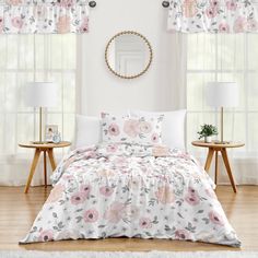 a white bed with pink flowers on it