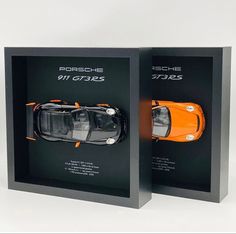 an orange sports car is in a black box with the words porsche 9117s on it