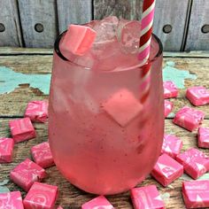 a pink drink with marshmallows on the table