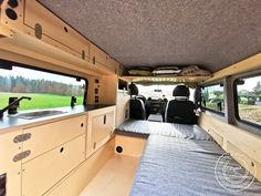 an interior view of a camper van with the bed pulled up to the side