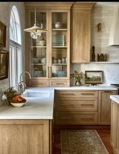 a kitchen with wooden cabinets and white counter tops