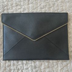 Black Rebecca Minkoff Leather Clutch - 10.5/7.5 Inches. Brand New, Never Used In Perfect Condition. I Also Have The Protective Bag To Ship It In. It Has A Gold Zipper Detail Around The Front Edges. The Inside Is Lined In A Black And White Pattern With A Button Close. 6 Individual Credit Card Slots Inside. Everyday Black Clutch With Zipper Pouch, Black Everyday Envelope Bag, Black Clutch With Zipper Pouch For Everyday Use, Black Office Clutch With Magnetic Closure, Black Envelope Bag For Everyday, Black Zipper Pouch Clutch For Everyday, Chic Black Envelope Bag, Formal Black Shoulder Bag With Zipper Pouch, Office Clutch With Removable Pouch In Black