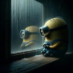 a minion sitting in front of a window next to a rain soaked glass wall