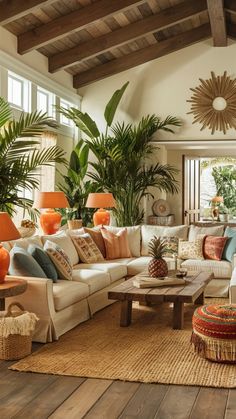 a living room filled with lots of furniture and plants on top of a wooden floor