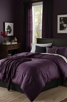 a bed with purple comforter and pillows in a room