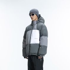 The Patchwork Down Jacket combines simplicity, avant-garde style, and vibrant energy. It features a Morandi color palette with a three-color splicing design, a logo print on the left waist, and an adjustable hood hem. The cuffs and jacket hem are snug, and the lining is made from anti-drilling velvet fabric. Filled with 268G of high-quality white duck down, this jacket is made from premium fabric and is slightly oversized.Morandi color scheme with three-color splicing design. Logo print on the l Urban Puffer Jacket For Winter Sports, Gray Color Block Winter Outerwear, Modern Nylon Hooded Jacket, Winter Gray Color Block Outerwear, Modern Nylon Hooded Jacket For Streetwear, Functional Puffer Jacket With Double-lined Hood For Streetwear, Hooded Color Block Winter Outerwear, Winter Hooded Color Block Outerwear, Winter Color Block Hooded Outerwear