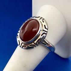 * Designer Mexico Taxco CII Sterling Silver 925 Red Carnelian Statement Ring * Ring Size: 10 * Top of Ring measures: 1.0" x 3/4" * Oval Red Carnelian total carat weight: approximately 5.5 tcw * Weight: 6.6 tgw * Marked: Mexico*CII*925 * Condition: Great * S391    Exported By ExportYourStore :) Red Carnelian Hallmarked Rings, Luxury Carnelian Oval Cabochon Rings, Red Carnelian Rings With Polished Finish, Red Carnelian Ring With Polished Finish, Red Polished Carnelian Rings, Red Carnelian Oval Cabochon Ruby Ring, Red Sterling Silver Oval Cabochon Ring, Collectible Red Carnelian Ring, Carnelian Cabochon Ruby Ring