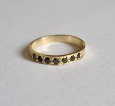 Handmade delicate Black Onyx, half eternity stacking ring, stoned with 7 beautiful shiny Onyx, diamond shaped faceted gemstones. This multistone eternity ring is beautiful alone or stacked together with other rings and is delicate and pretty on your finger. The ring is available in nickel free, 14k gold plating over brass or silver base as well as, solid silver or 9k and 14k solid gold- yellow, white or rose gold. A perfect engagement ring or just a beautiful gift for you. Gemstones alternative Onyx Band Ring, Black Onyx Diamond Ring, Black Onyx Gold Ring, 14k Gold Black Round Band Jewelry, Black 14k Gold Round Band Jewelry, Black 14k Gold Band, Black Minimalist Stackable Rings For Anniversary, Minimalist Black Stackable Rings For Anniversary, Black Stackable Rings With Round Band