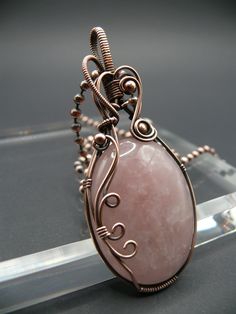 Handmade Large rose quartz statement pendant wrapped in antiqued copper. Beautiful rose quartz with its lovely pink colour, is considered a stone of heart. It is the crystal of unconditional love. It carries a feminine energy of compassion and peace, tenderness and healing, nourishment and comfort. It awakens the heart to its inner love, it provides a deep sense of personal fulfilment, allowing one the capacity to give and receive love from others. This beautiful gemstone is wrapped in oxidized Luxury Unique Wire Wrapped Jewelry, Wire Wrapped Leaf Pendant, Pink Wire Wrapped Copper Jewelry, Pink Wire Wrapped Copper Wire Jewelry, Pink Copper Wire Wrapped Jewelry, Pink Copper Wire Jewelry For Gifts, Receive Love, Wire Jewelry Patterns, Give And Receive