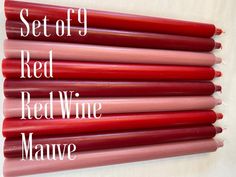 six red wine candles are lined up on a white surface with the words set of 9