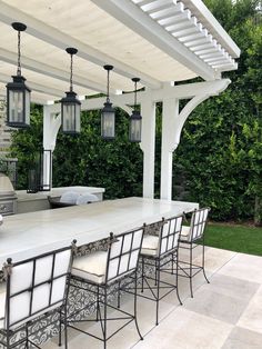 an outdoor kitchen and dining area is shown